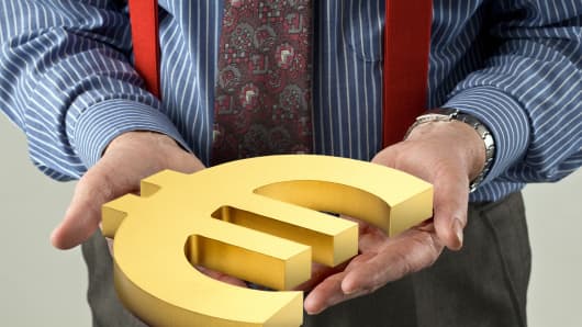 Banker holds giant Euro symbol